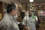 During a section on hydroponics, growing plants in liquid nutrients, Jose Diaz explains procedures to  Evenson Vernat, a student from Haiti. It was the study of hydroponics that caught his student’s attention.  His class’s enthusiastic response to the project temporarily assuaged his doubts about his future in teaching.