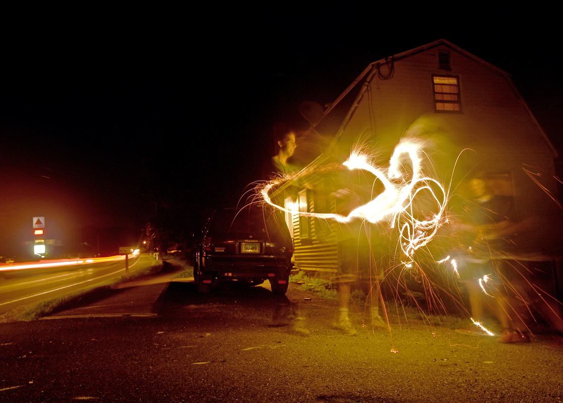 Joey Carbone and Katlynn Morrison light sparklers in Carbone's driveway two nights before July 4th. 