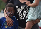 Daniel Sullivan, 4, left, of West Hartford, stands with his family at an {quote}I Can't Breathe{quote} rally at the State Capitol late Friday afternoon. Members of different organizations and communities were there to rally against police violence and killings of people of color. 