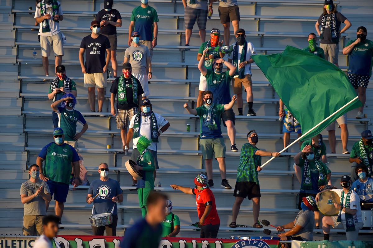 Socially distanced Hartford Athletic fans cheer their team on against Loudon United FC at Dillon Stadium. 