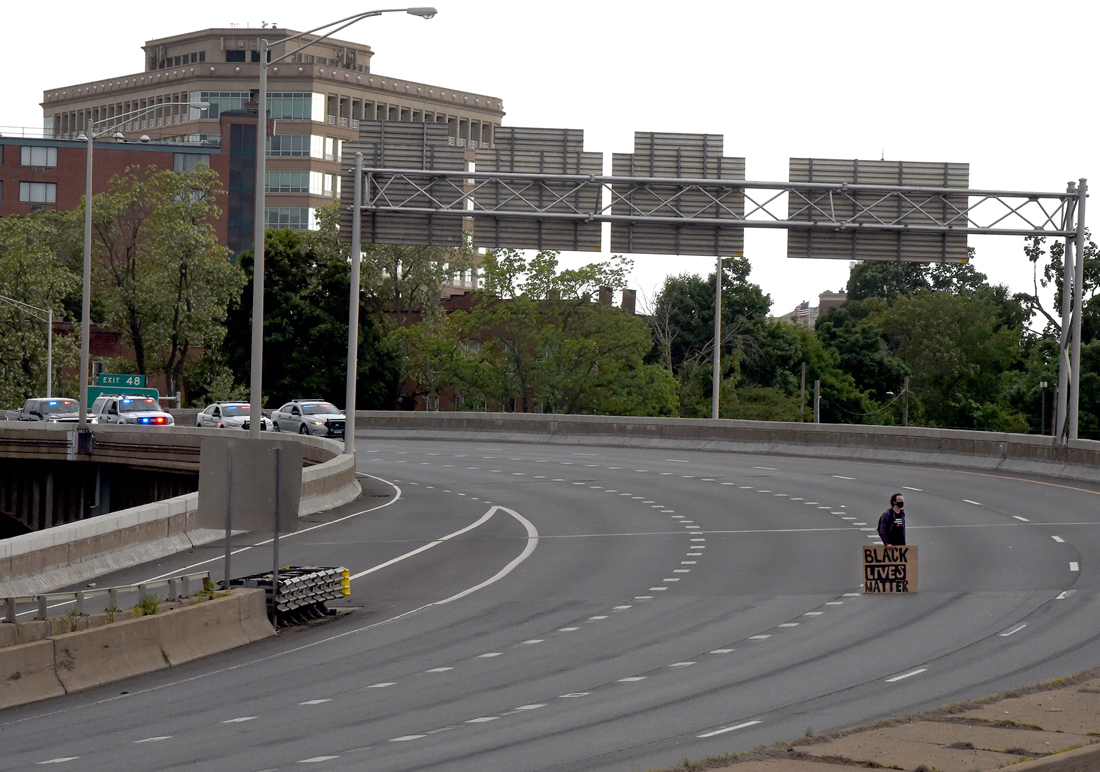 Hartford, CT - 6/1/20 - A protester remains on Route I-84 East as others (not pictured) block I-84 West Monday evening demanding action against police violence against people of color. Photo by Brad Horrigan | bhorrigan@courant.com