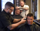 Ryan Howley, top, cuts Gene Wood's hair as Angelo Exarhoulias, left, cuts Jon Petrichenko's hair at The Barber Shop. Barbers and shop co-owners Hawley and Exarhoulias have now been in business together for 10 years and have been at the shop's current Brooklyn location for 4 years.  