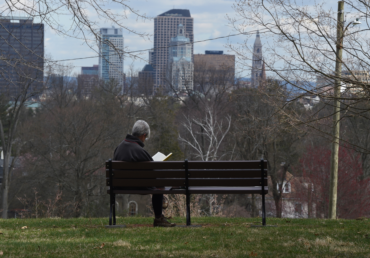 Mariann Yarborough reads a book at Sunrise Overlook in Elizabeth Park during the COVID-19 pandemic. 