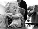 Rose Aiello gives her new doll a kiss at The Atrium at Rocky Hill Wednesday afternoon. Aiello and her fellow residents who suffer from dementia were given dolls or plush dogs Wednesday afternoon by members of the Rotary Club of Wethersfield/Rocky Hill. Aiello, a mother herself, immediately took to the doll. The goal is to give people with dementia life chores and a sense of purpose. 