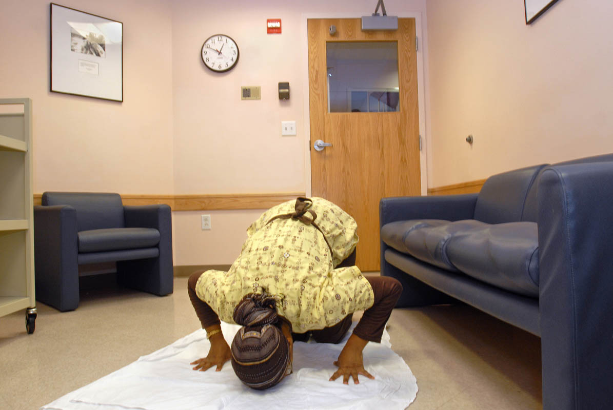Yale-New Haven Hospital personal care assistant Rajeeyah Haneef prays in a lounge on her break.  