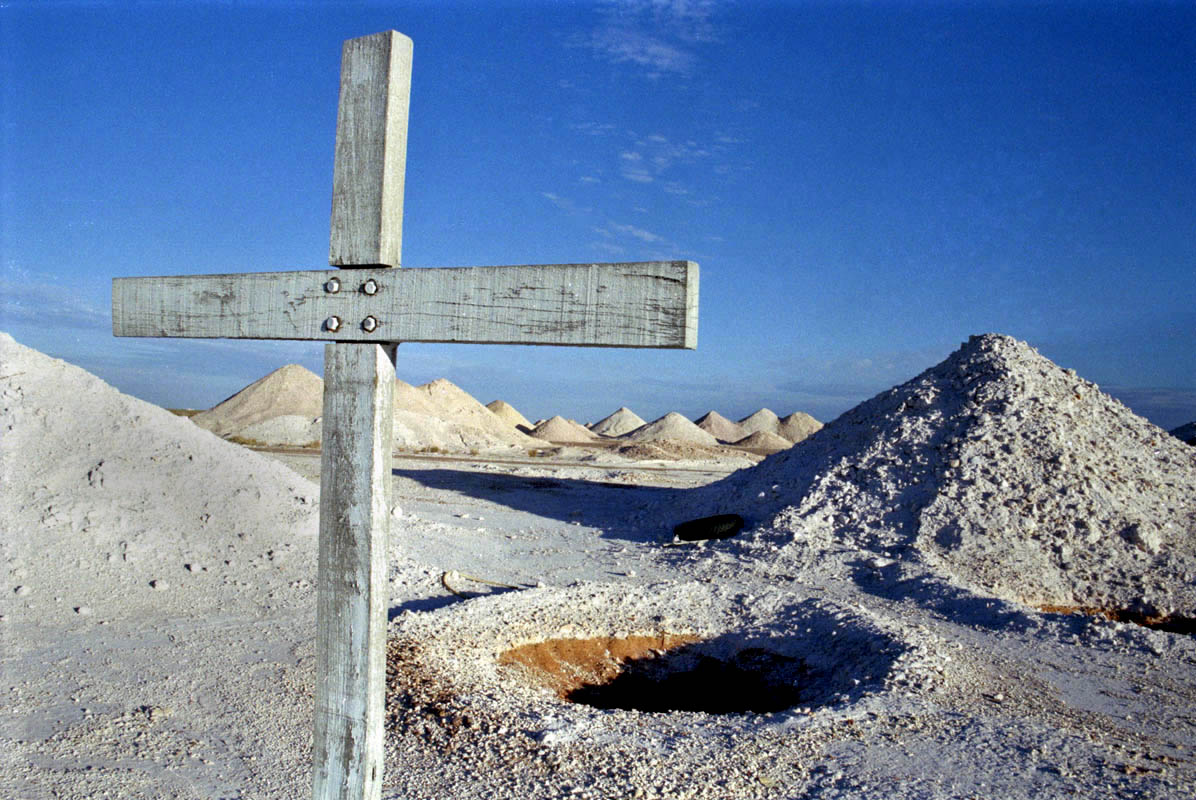 A cross stands in memorial to a fallen opal miner in Coober Pedy, Australia. 