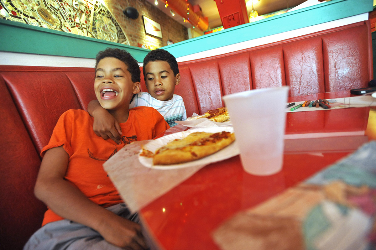 Allen and his younger brother Javy enjoy pizza in Jersey City. 