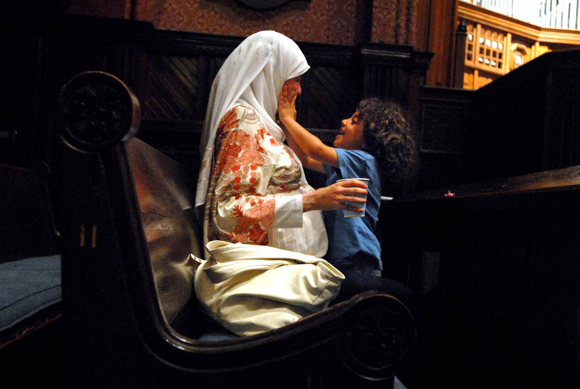Marwa El-Sayed and her son Adam Masoud, 4, enjoy a private moment during a {quote}community iftar{quote} at Battell Chapel.  An iftar is when Muslims break their daily fast after dusk during the month of Ramadan.  For this particular iftar, Yale Muslims were encouraged to invite friends regardless of the religious denomination.  El-Sayed and her son live in Cairo, Egypt, but are visiting a friend who is a professor at Yale.