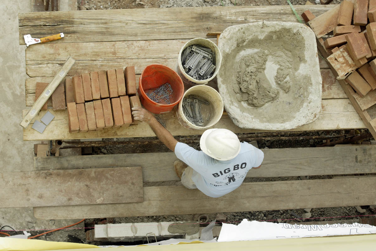 A mason works on a school construction project in North Plainfield, New Jersey