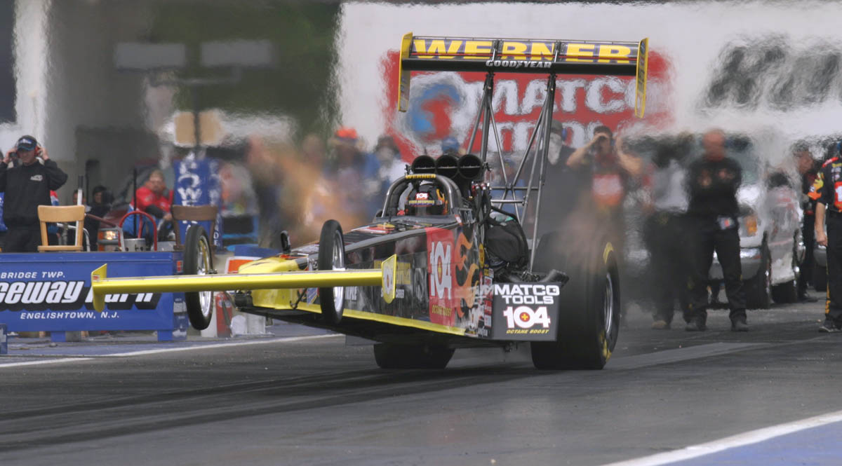 Clay Millican lifts the front end of his dragster at the start of a run down the quarter mile strip during the NHRA Supernationals at Raceway Park in Old Bridge, New Jersey.