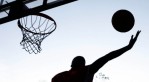 A player grabs a rebound during an adult summer basketball league at Saint Peters Park in Newark, New Jersey.