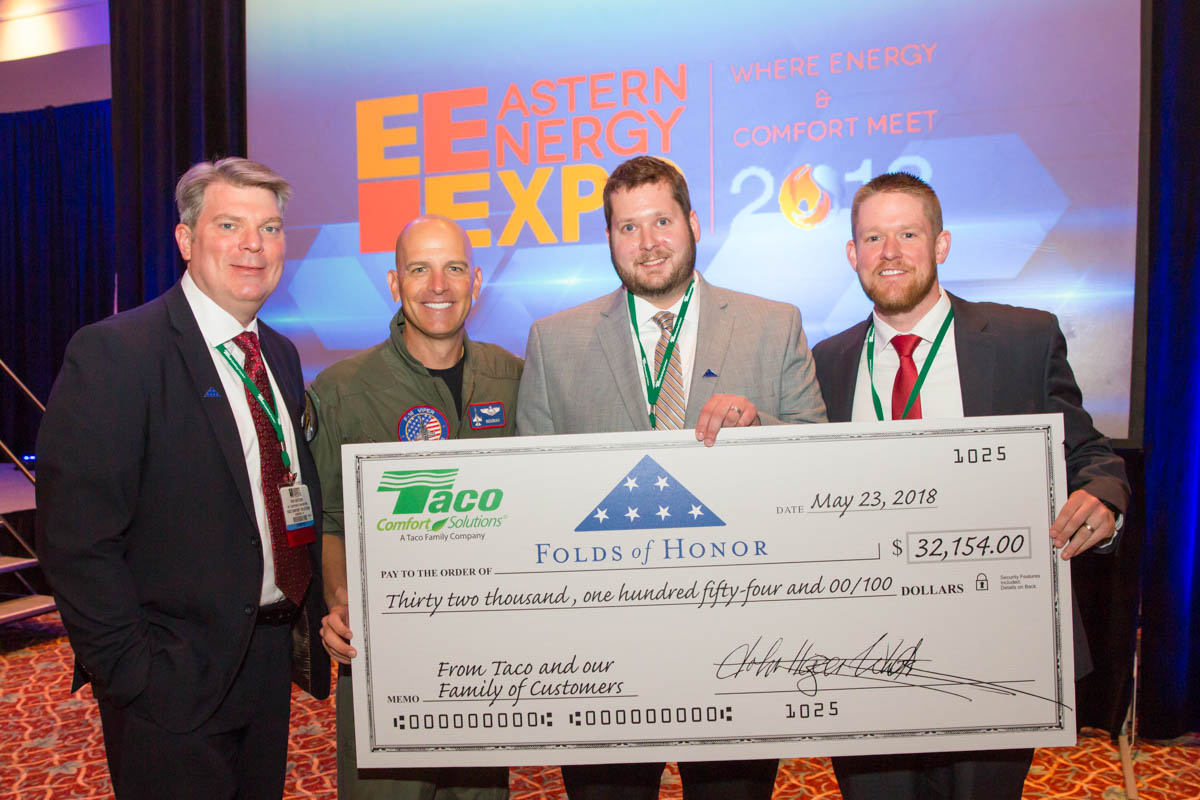 Four men standing together during a check presentation at the Eastern Energy Expo at Foxwoods Resort and Casino in Mashantucket, CT on 5/22/18. 
