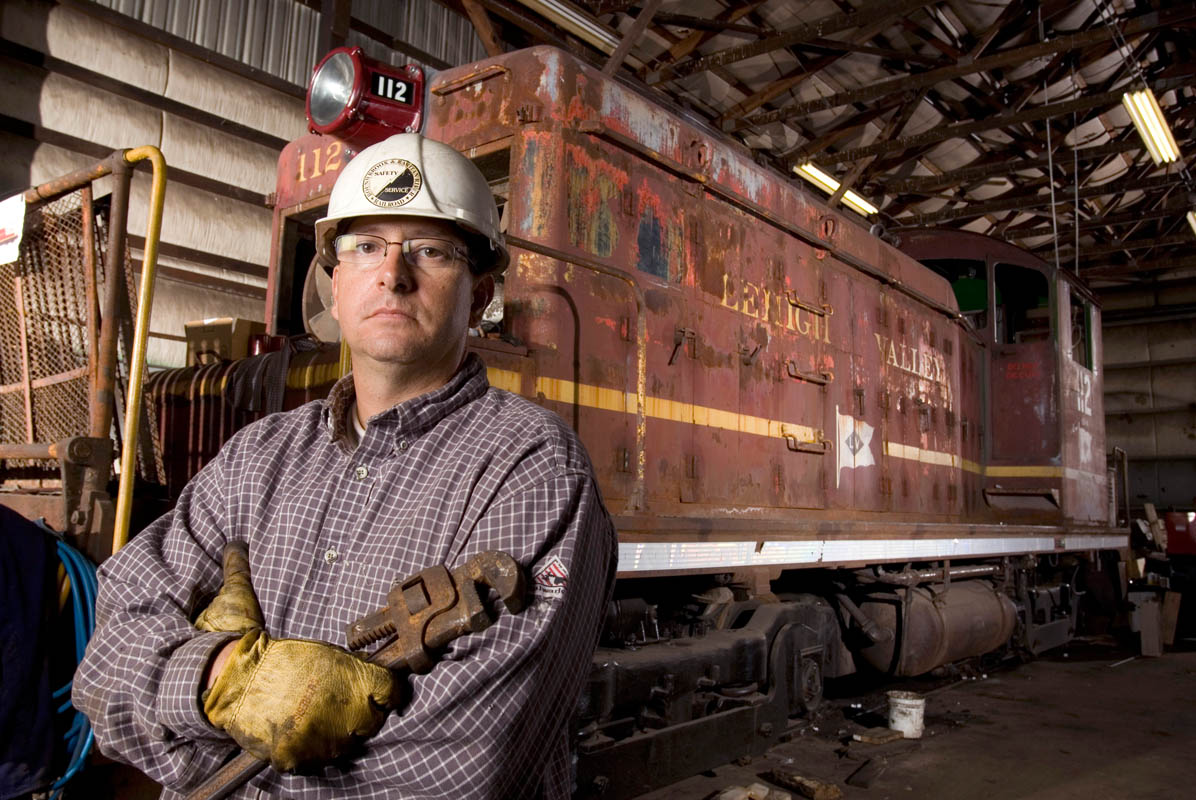 Owner of a Locomotive Rebuilding Service, stands with one of historic locomotives