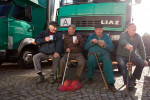 Men sit together during a traditonal carp harvest in the village of Kondrac, Czech Republic, on October 13, 2012.