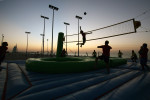Players from Brazil and the Netherlands in action during a bossaball match, a new sport which started in Brazil, played on an inflatable court with a trampoline to bossa music, at the beach in Dubai on November 26, 2009. 