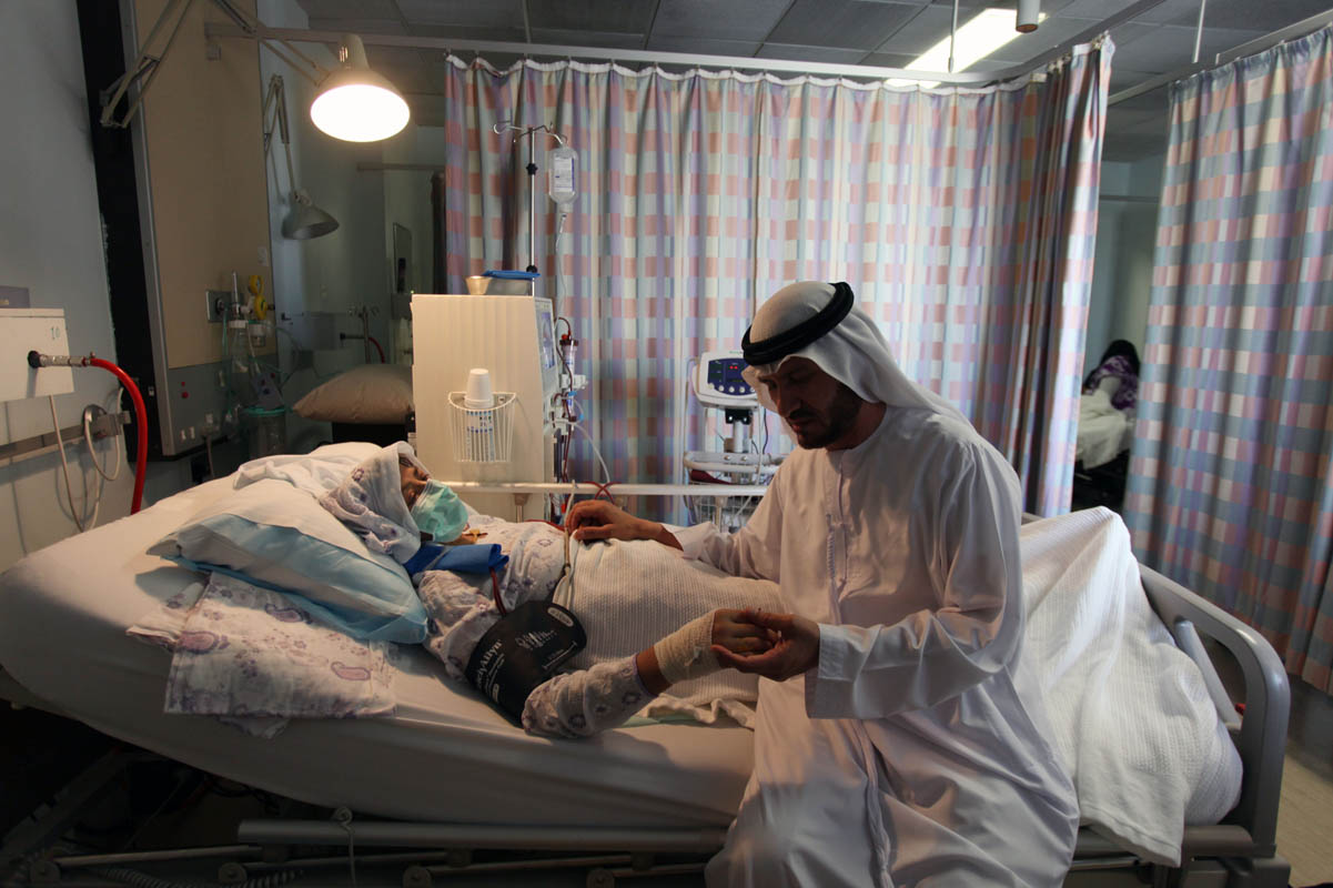 Syed Muhammad Amroze sits with his wife Hussanzari, 46 years old, while she undergoes dialysis treatment at the Qassimi hospital in Sharjah on May 18, 2010. 