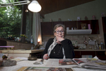 DOEL, BELGIUM - May 11:  Emilienne Driesen, pictured in her home in the village of Doel, on May 11, 2014.  The 80-year-old is known as The Angel of Doel, and is one of 25 remaining residents in the village and has lived there her entire life. The 400-year-old village is wedged between a nuclear power station and the ever-expanding Port of Antwerp. Many villagers left in the late 1990s when the regional government outlined plans to expand the port and residents were offered premiums to sell their homes. Once having had a population of around 1,300, it is now home to a mere 25 occupants who refuse to leave. An initiative, Doel 2020, has been established by the remaining inhabitants to fight the proposed port expansion and subsequent demolition of the village, the deadline for which is set for 2020, but the outcome remains uncertain. After years of neglect, squatting, looting, and uncertainty, this modern-day ghost town is a haven for street artists who have turned the dilapidated houses into a colourful open-air gallery attracting urbex photographers and the curious alike.  