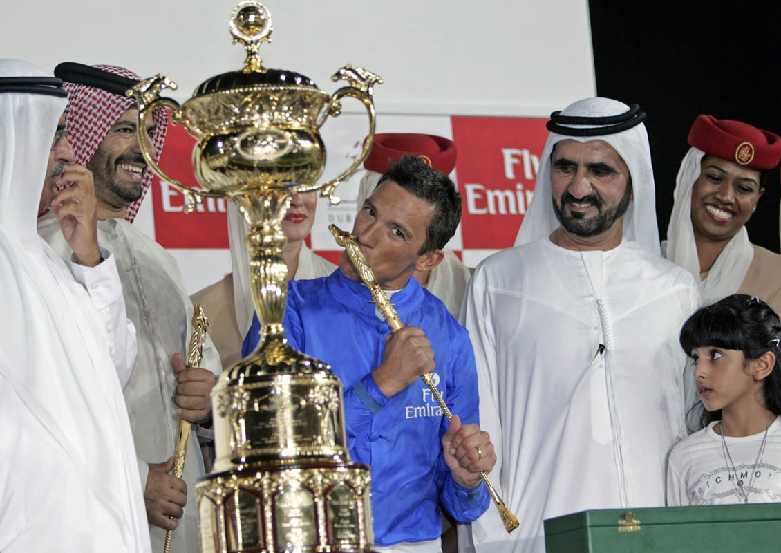 HH Sheikh Mohammed Bin Rashid Al Maktoum, Vice President and Prime Minister of the UAE and Ruler of Dubai (R) watches on as jockey Lanfranco Dettori celebrates his big win worth six million US$ at the Dubai World Cup 2006 which took place at the Nad Al Sheba race track on March 25, 2006. Dettori was riding Electrocutionist. 