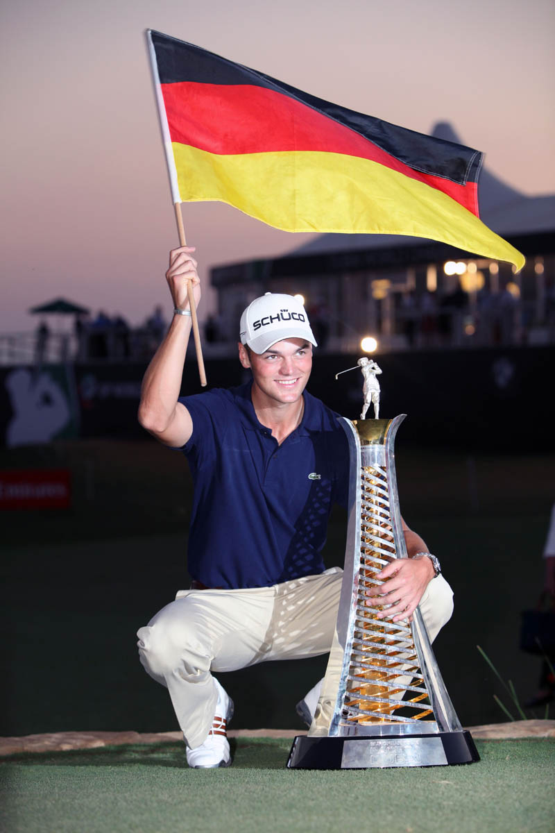 Martin Kaymer of Germany poses for photographs with the Race to Dubai trophy on the fourth and final day of the Dubai World Championship at the Earth Course of the Jumeirah Golf Estates in the Gulf emirate on November 28, 2010. Kaymer clinched the top European position. AFP PHOTO/RANDI SOKOLOFF 