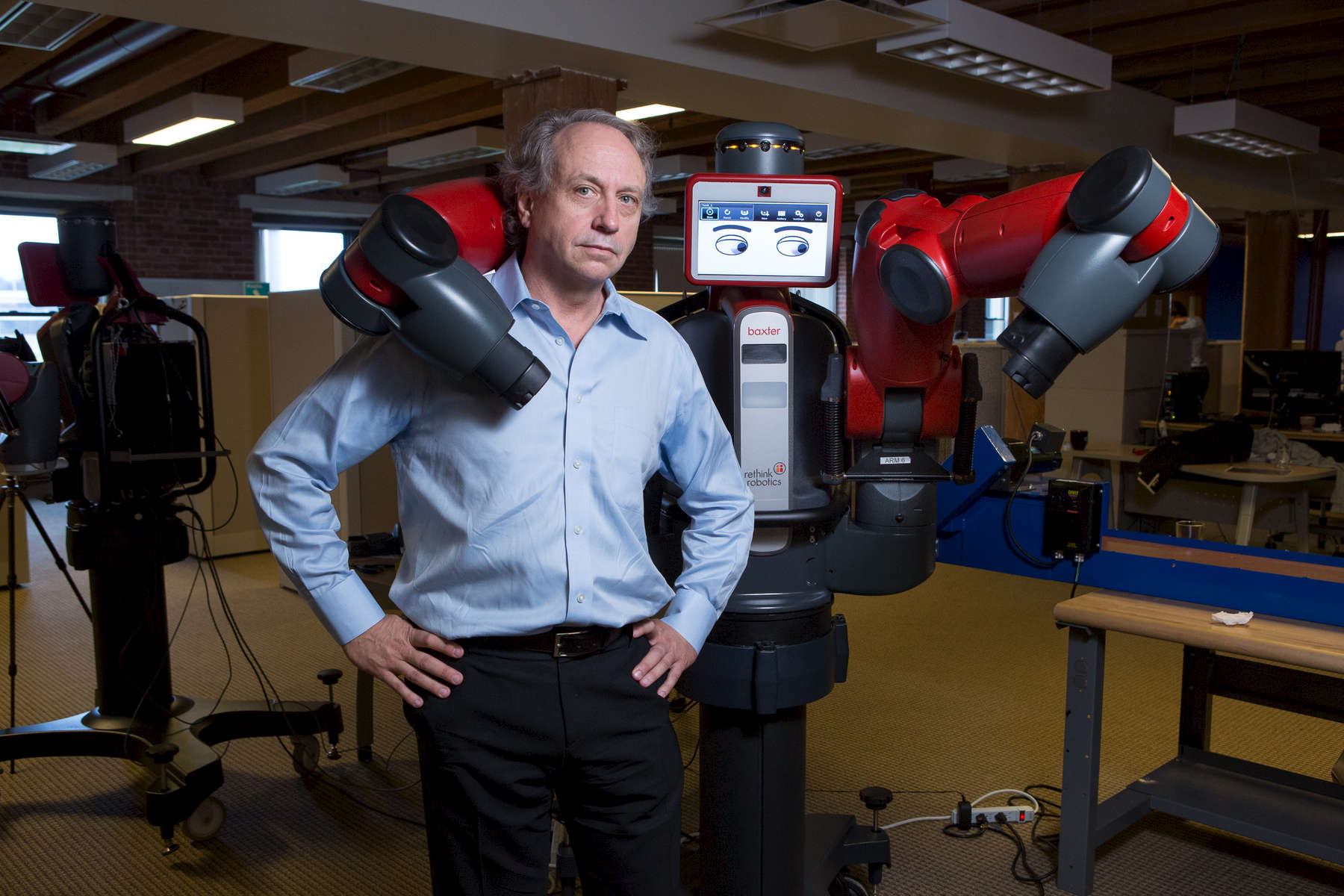 Boston, MA., September 5, 2012: Rodney Brooks, founder, chairman and CTO of Rethink Robotics with {quote}Baxter{quote} a robot that can change facial expressions depending on the task that it is performing. The company says it is developing a new generation of robots to improve productivity in manufacturing environments. Photograph by Evan McGlinn for The New York Times.