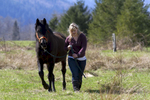 Alexis Blakey, age 19, from Oso Wash. walks with a stallion on Summer Raffo’s farm in Oso, Wash. on April 1, 2014.  Blakey was a friend Raffo and headed to her farm immediately after hearing Raffo was missing after the mudslide on March 22, 2014.  She has been caring for the 16 horses daily since.   “This was her life,” said Blakey.  “She loved horses and loved caring for them.  I’m really going to miss her.”