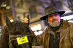 Steve Beckmann, owner and driver of Sealth Horse Carriages, rubs his draft horse, Amos', ears to calm him down during a break between taking passengers for rides in downtown Seattle, WA on December 17, 2017. (© Karen Ducey)