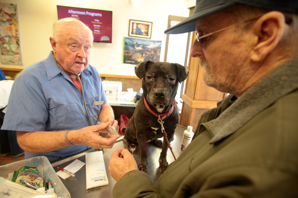 Danny Price (right) and his dog Pepper, 9 years, Homeless and low income people bring in their pets to see veterinarians and pick up food at the Doney Memorial Pet Clinic located in the Union Gospel Mission in Seattle, WA on June 25, 2016. (photo © Karen Ducey Photography)