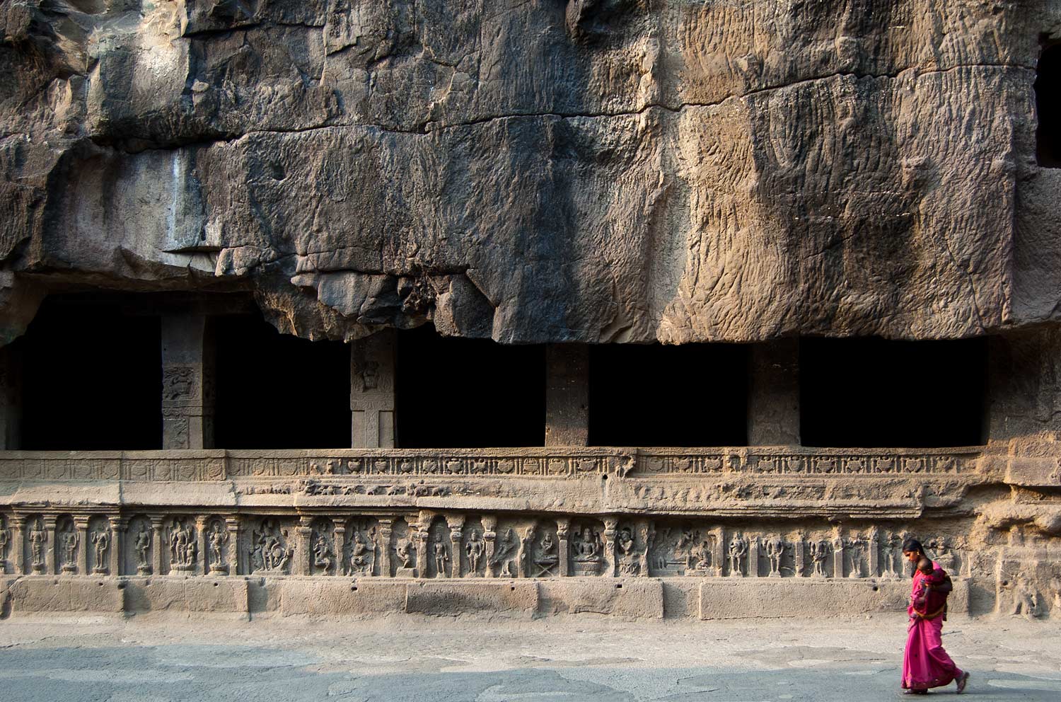 Largest rock carving at Ellora, with a Dravidyan temple at its center and halls carved out of the surrounding cliff face, shown here