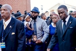{quote}A Father's Solemn Walk{quote}Flanked by family members and the Nation of Islam, Michael Brown Sr. walks into the Friendly Temple Missionary Baptist Church to attend the funeral service of his son Michael Brown Jr.