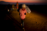 Young Syrian girl carrying the family's belongings, leading the way across the border to Serbia.