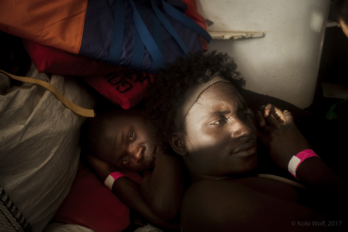 Africans Migrants rest on the deck of the Procativa open arms ship  after being rescued in the central Mediterranean, in international waters off the Libyan coastal town of Sabratha. 
