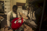African Migrants from Senegal holding her baby in the {quote}hospital{quote} of the Procativa open arms ship  after being rescued in the central Mediterranean, in international waters off the Libyan coastal town of Sabratha. 