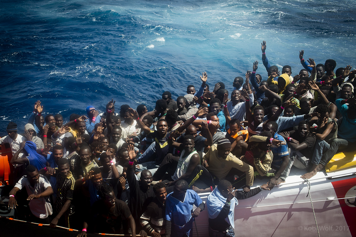 Refugees and immigrants in the Italian coast guard ship on thrie way to lampedusa island in Italy. 