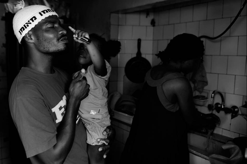 A family from Ivory Cost in Their apartment  days before the Deportation in the old bus station Southern Tel Aviv where most of the africans refugee are living. The couple immigrated separately from the Ivory Coast and met in Israel. the children were born in Israel and speaking Hebrew and all what they know that Their country and Nationality is Israel.  
