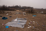 Blankets, sleeping bags, empty bottles and food wrappers left on the ground, after scores of refugees spent the night out in 0 Celsius temperatures