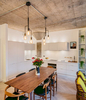 Kitchen area with concrete walls and large wooden table in furnished loft apartment of complete internal redesign project of former warehouse building in Shoreditch. Interior Designer - Warret Julien