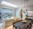 Dining / Kitchen area of contemporary interior design apartment in Russell Court. Large slate table with high-end bespoke internal fixtures and fittings in kitchen