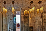 Detail of landing area in Private House in Èze with Moroccan style lanterns and distessed mirrored wall and door