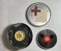 Joseph BEUYS (1921-1986)The TableOriginal 16 mm reel and BASF magnetic sound tape in film cannister, label with oil paint (Browncross)7 1/2 × 1 7/10 in (19 × 4.2 cm)Edition of 200