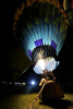 At the Third Annual Hot Air Balloon Festival in Santa Paula, Calif., on Friday, July 30, 2010 a group of men light up the hot air balloon with flames during the Glow event while people crowd around and watch. {quote}It takes about twenty minutes to blow up the balloon,{quote} Dean Davey said from start to finish. 