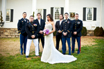 Winter Bride, Sarah Ann Schultz, 28, from Laguna Niguel, Calif., is surrounded by her Groom, Duncan Mark Carlto, 26, from Laguna Niguel, Calif., and his groomsmen on their wedding day at the Vesuvius Vineyard in Iron Station, North Carolina on Saturday, December 29, 2012. The bride was a strong women bearing the 40 degree winter weather only wearing her wedding dress. 