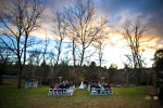 The ceremony for Sarah and Duncan Carlton takes place on the lawn during sunset near a subtly flowing creek at the Vesuvius Vineyard in Iron Station, North Carolina on Saturday, December 29, 2012. The bride choked up a bit with joy during her vows with her husband.  