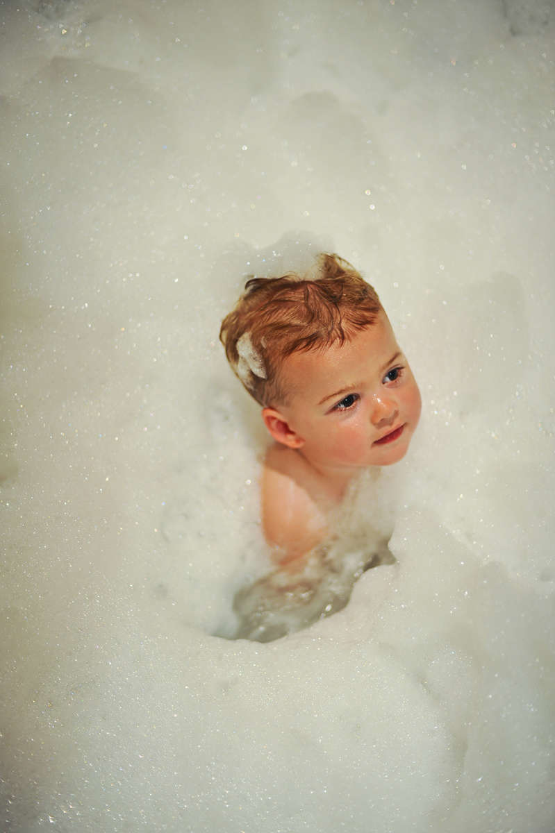 Zander Obloj, 1, from Fenton, MI, is splashing in a bath full of bubbles at his Aunt Debbie and Uncle John Reidingers' house in Lake Forest, Calif., on Saturday, September 14, 2013. Obloj is drawn to water, his mom, Heather Obloj, from Fenton, MI, calls him {quote}a little fish.{quote} (Photo by: Meagan Reidinger © 2013)www.meaganreidinger.com