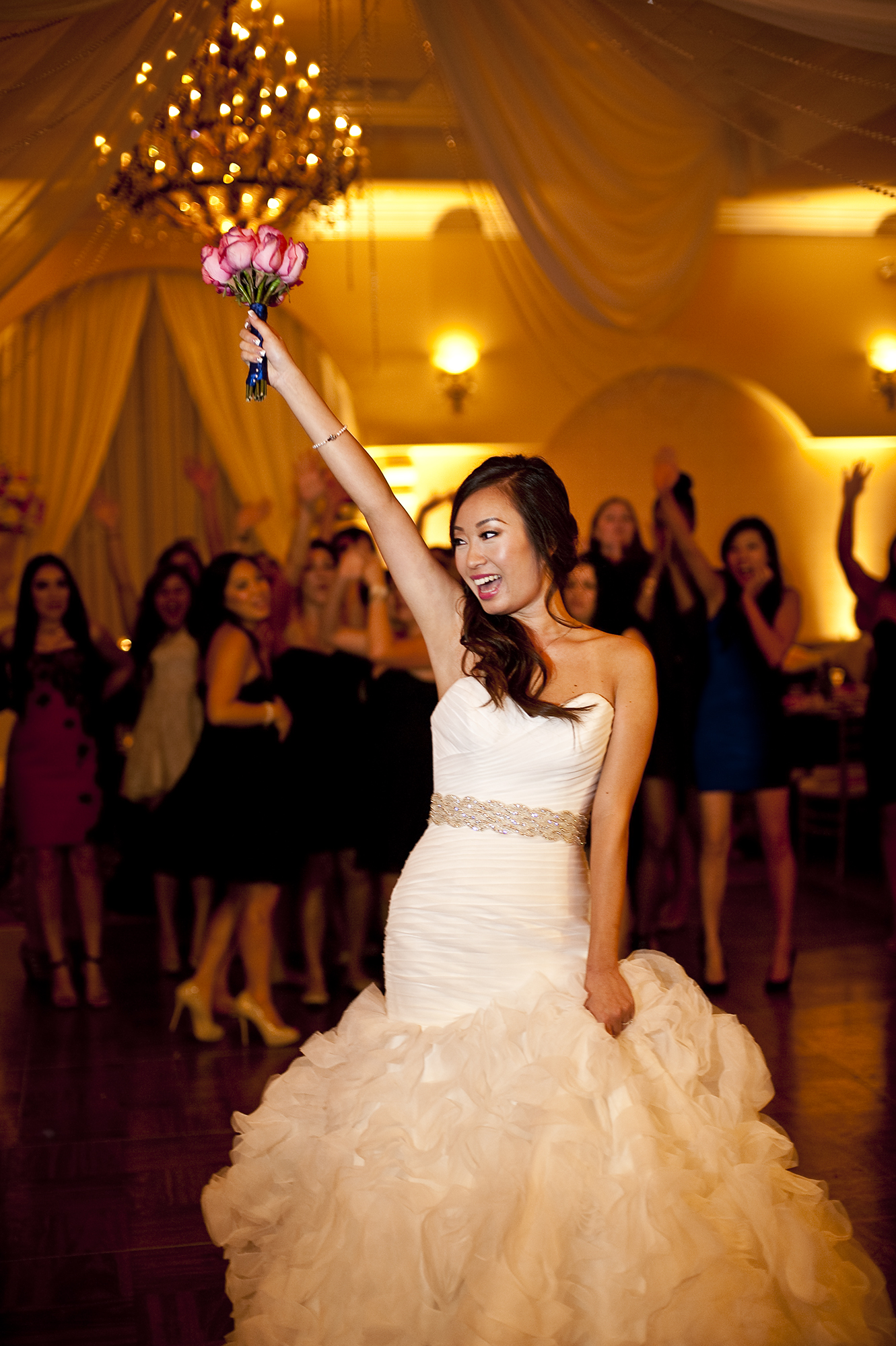 The bride, Jessica Alvidrez, rallies all her single ladies to the dance floor for her bouquet toss at The Villa in Westminister, Calif., on Saturday, November 16, 2013.  The women cheered and raised their arms in the air as the bride to be leaped and caught it on the ground.