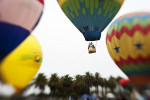A group of people are lifted in the air held by lines to the ground while in a hot air balloon at the Third Annual Hot Air Balloon Festival in Santa Paula, Calif., on Saturday, July 31, 2010.
