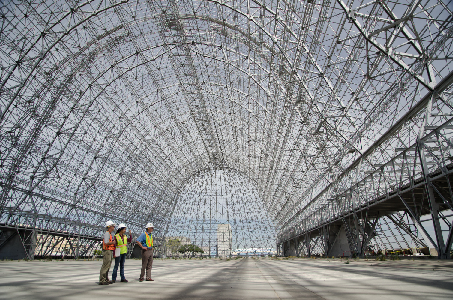 Hangar One, completed in 1933 to house  the naval airship USS Macon, covers eight acres.  The exterior panels were removed in 2011-2012 due to leaking toxic chemicals and asbestos.