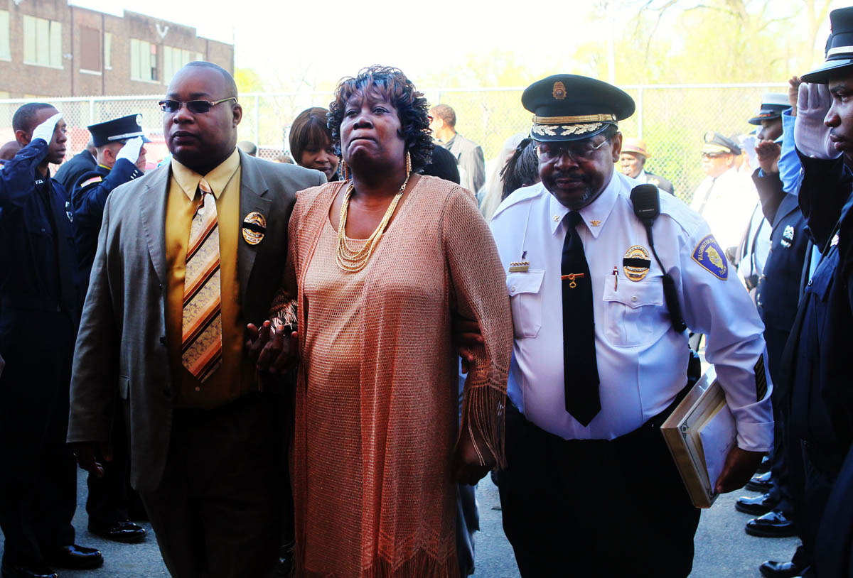 John Thornton, Jr., left, and Washington Park Police Chief Calvin Hammond, right, comfort Sharon Thornton, center, as they walk into the funeral service held for Washington Park mayor John Thornton, Sr. at Mount Calvary Church of God in Christ in Washington Park. Thornton was shot and  killed April 1, 2010.