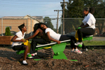 Twelve-year-olds Lacey McCray, Amahjanee' Patterson, Airriona McCray, and Tamijah Murphy crowd onto the teeter-totter on the playground across the street from the Christian Activities Center in the Olivette Park neighborhood in East St. Louis. A bar used to occupy the land where the playground sits. In 2005 the CAC purchased it with the hopes of adding the playground and the eventually a fine arts center and a dormitory for volunteers.