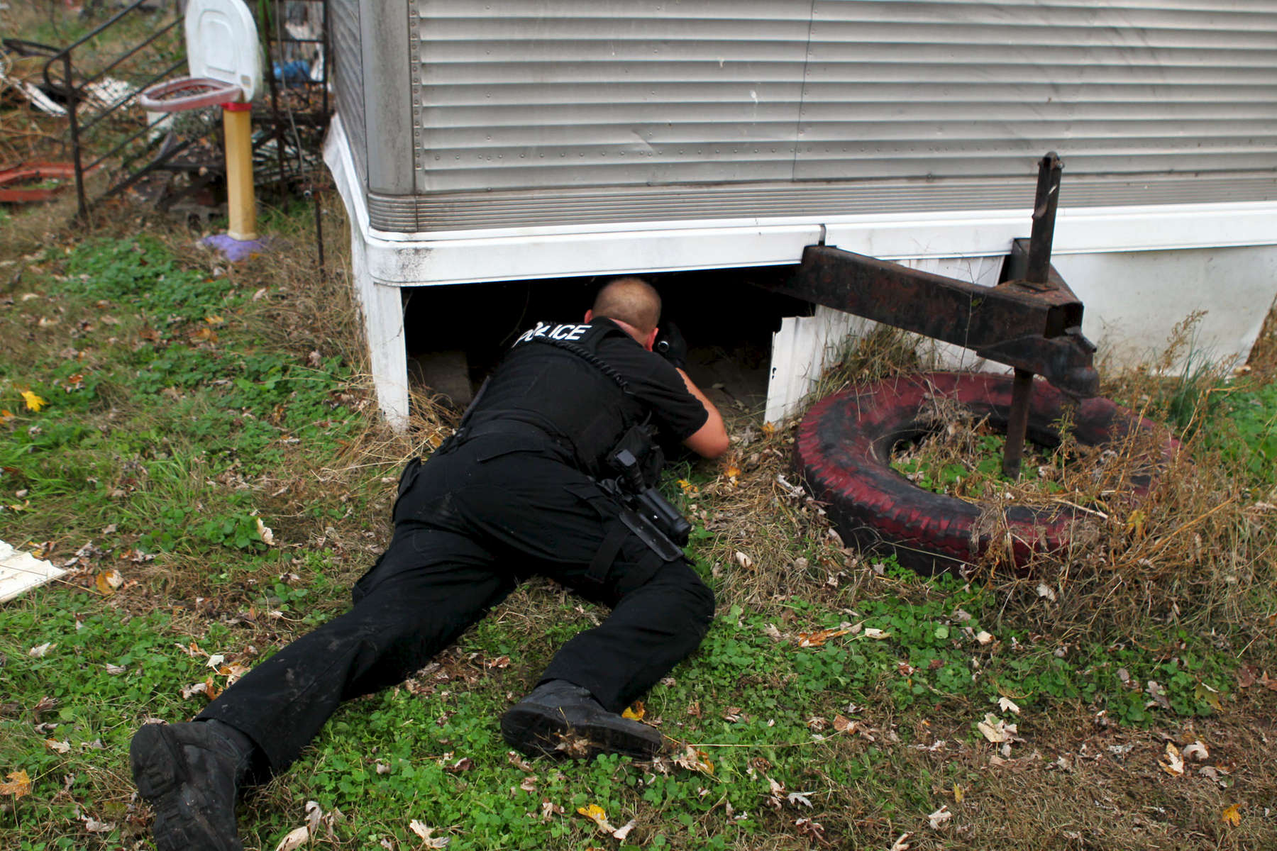 A Belleville police officer investigates the scene where a robbery suspect was found hiding under a mobile home.According to Belleville detective  Mark Hefferman, Police received a call around 6:40 am Monday morning about a robbery at the Circle K in Belleville. Police identified the car involved and attempted to make a traffic stop. The car fled and both suspects were found in unincorporated Collinville. One suspect was arrested without incident, the other was found under a mobile home in the 3200 block of University Street. 