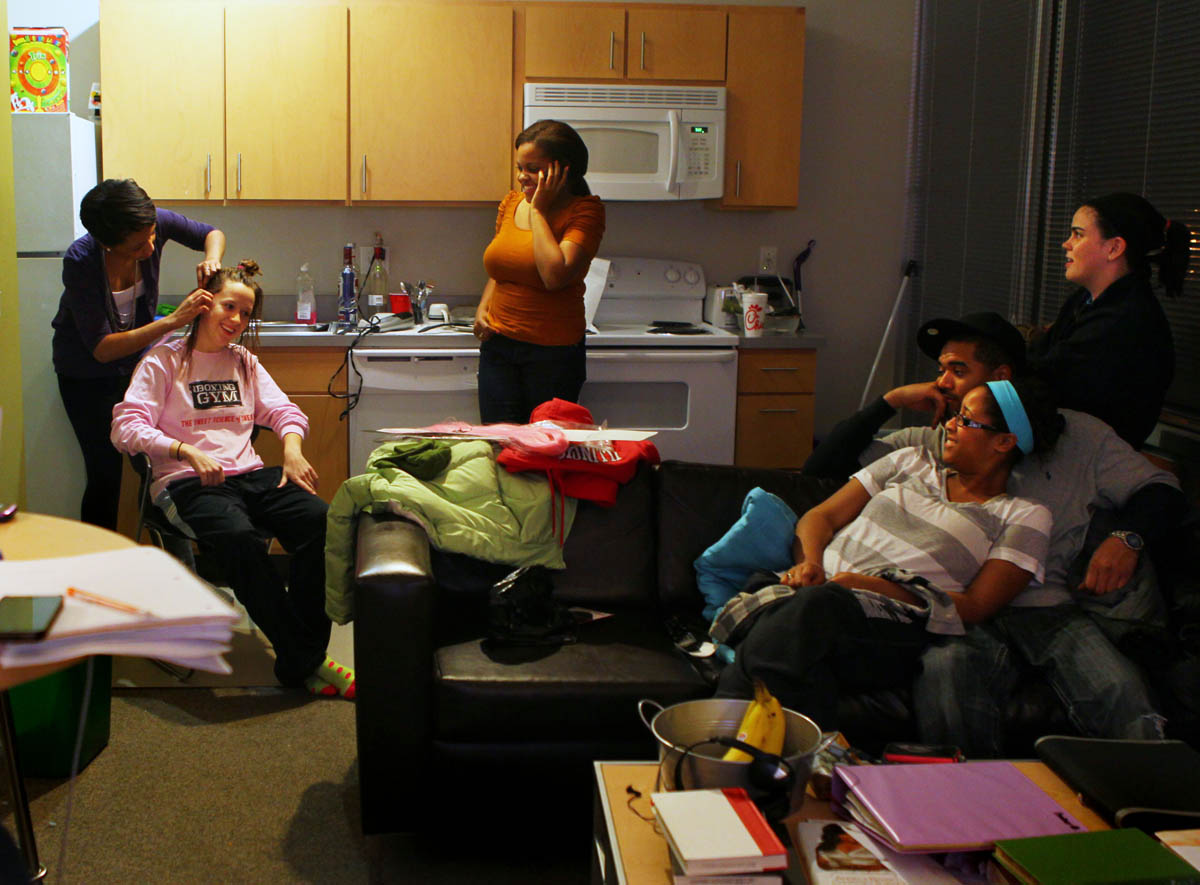 Amber Overton braids Rachel Wessling's hair as they hang out in Overton's dorm room at St. Louis University two days before her fight.  She mixes in strands of synthetic pink hair into the braids in honor of her nickname The Pink Panther. Also pictured are Jina DuBose (standing), Rachel Taylor (far right),  Cora Black and Dennis Tabb (on the couch).